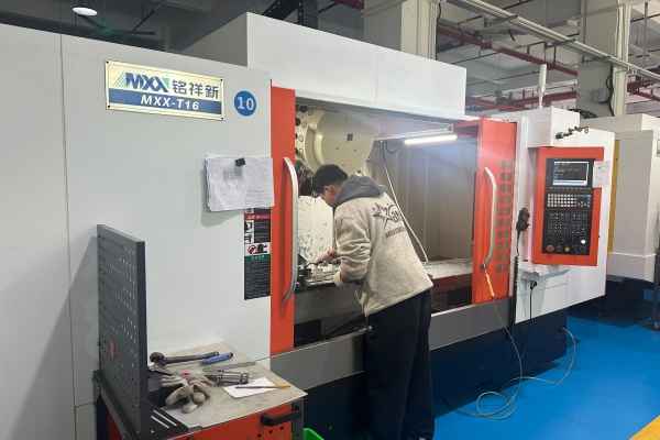 engineer operating CNC machining equipment