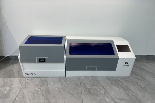 Front view of the pathology analysis instrument enclosure manufacturing process showing the dual-color split design.